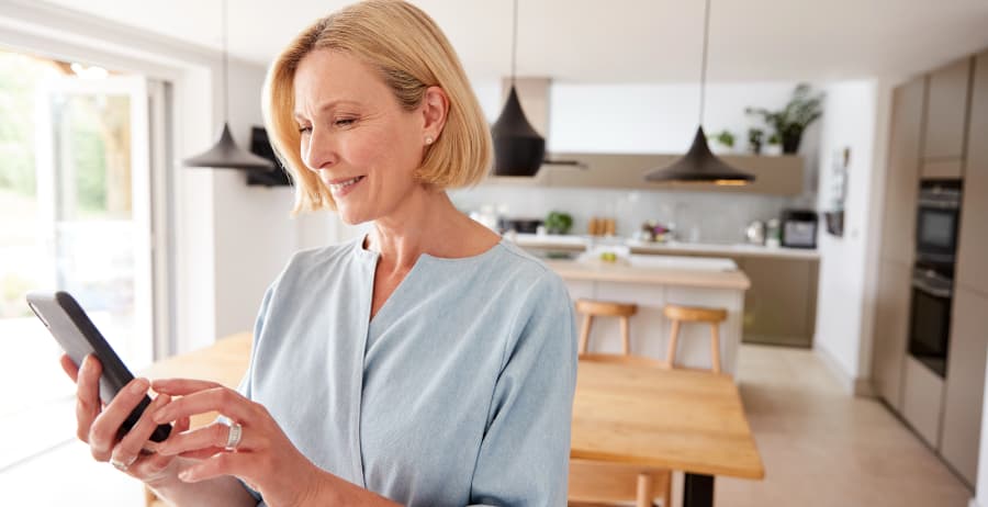 Woman using a mobile device in a stylish home